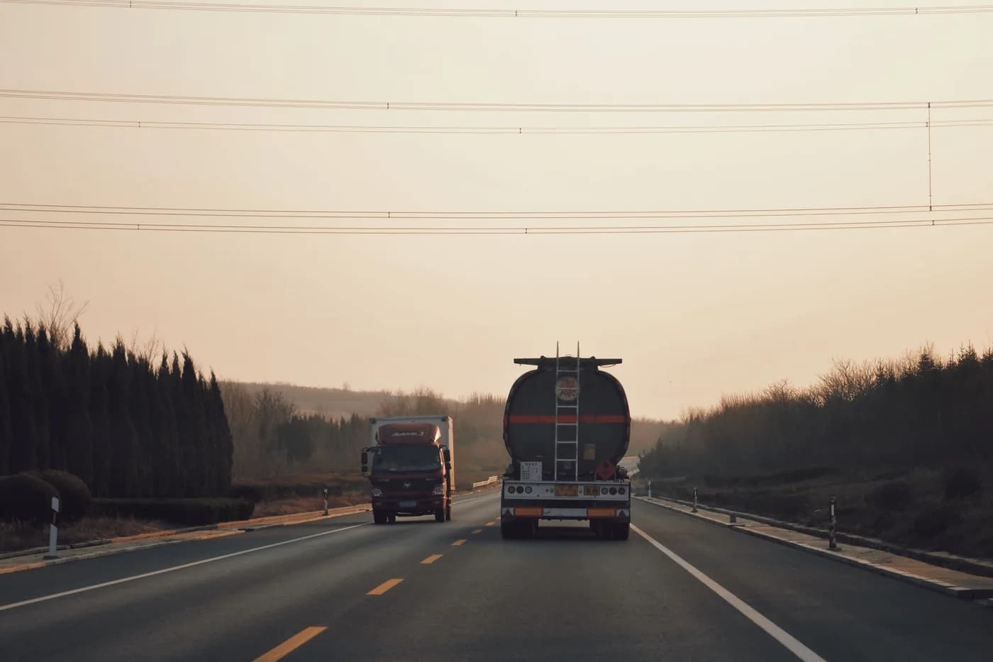 Freight trucks on a motorway at dusk